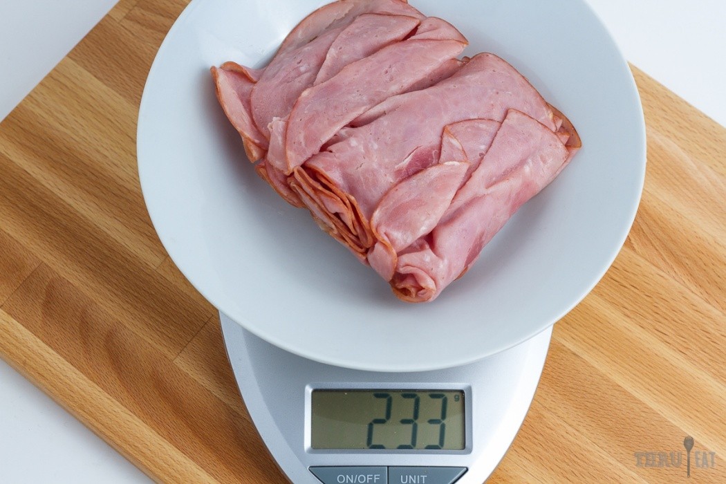 233 grams of sliced deli ham on a scale