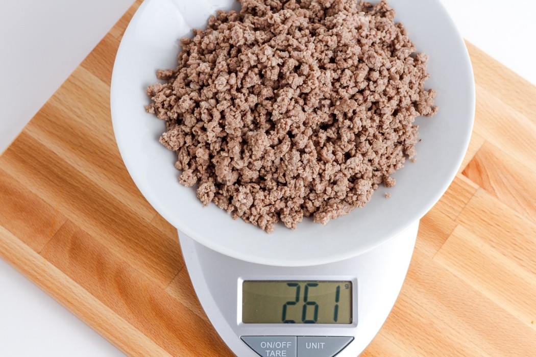 Cook, drain, and rinse ground beef thoroughly 261 grams of cooked ground beef on a scale