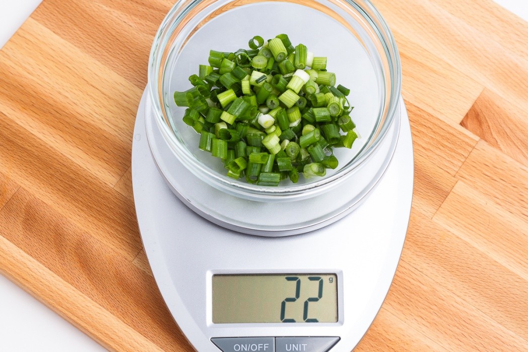 Chopped up the green onions before dehydrating 22 grams of green onion on a scale