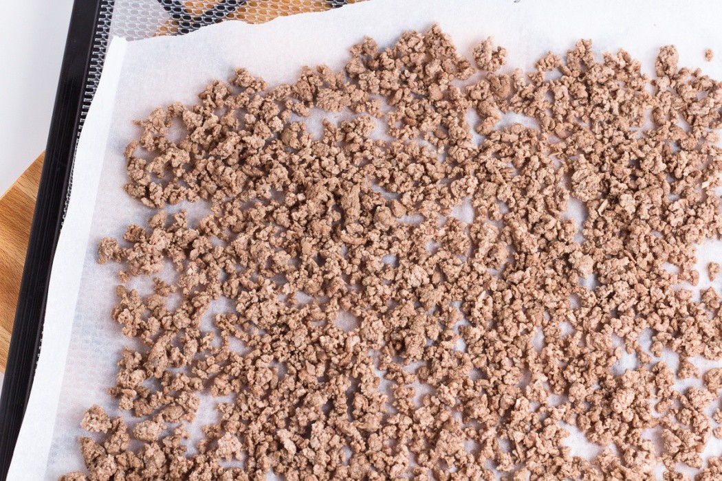 Make sure the ground beef is evenly spread and broken to small even size ground beef laid out on dehydrator tray