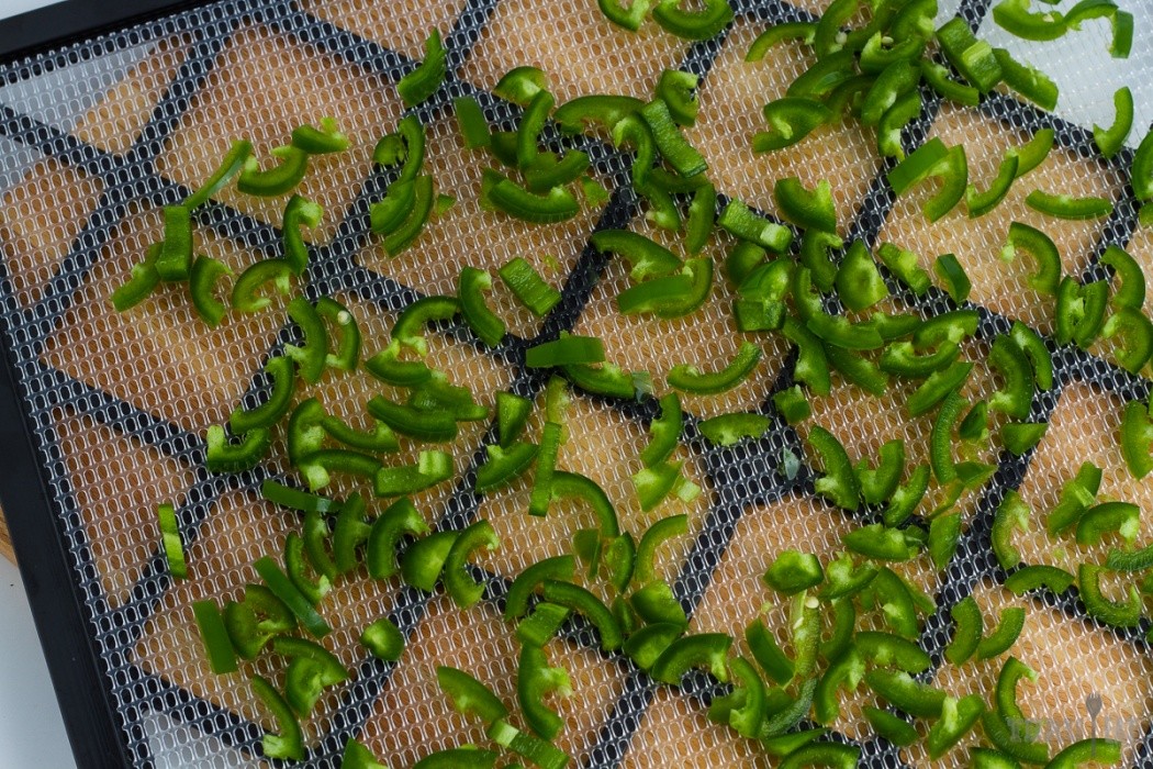 Spice up your backpacking meals with a little heat jalapenos on a dehydrator tray
