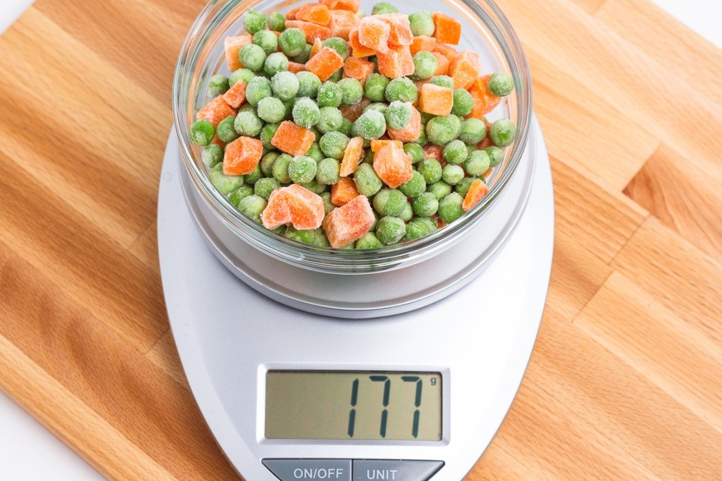 Frozen peas and carrots can be dehydrated straight from the refrigerator without thawing 177 grams of frozen peas and carrots on a scale