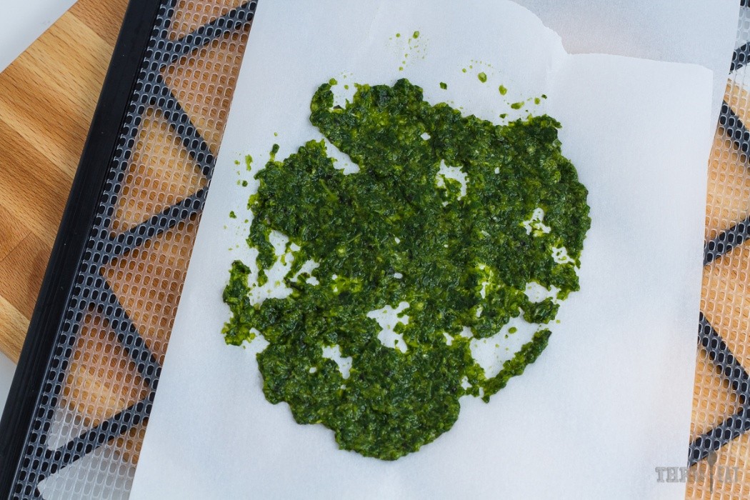 Spread pesto thinly for dehydrating pesto smeared on a dehydrator tray