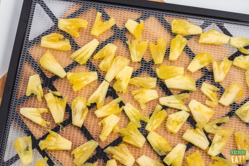 sliced pineapple on dehydrator tray
