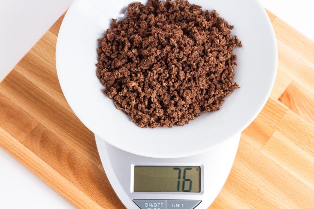 Dehydrated ground beef is significantly lighter and much darker 76 grams of dehydrated ground beef on a scale