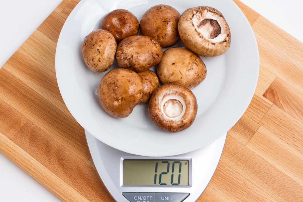 Baby bella mushrooms getting prepped for dehydration 120 grams of baby bella mushroom on a scale