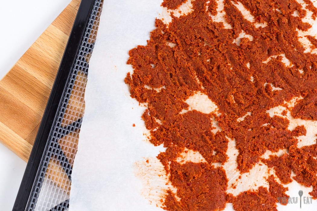 red curry paste spread on a dehydrator tray