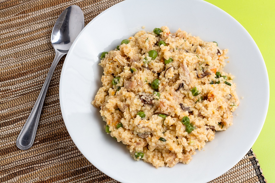 This is by far one of our favorite meals in terms of flavor and convenience plated cheesy chicken couscous with mushrooms, peas, and carrots