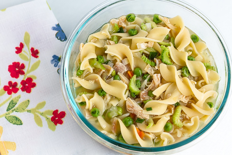 We call this a 'one bag meal' because the ingredients don't need to be separated bowl of chicken noodle soup with peas, carrots, celery, and mushrooms