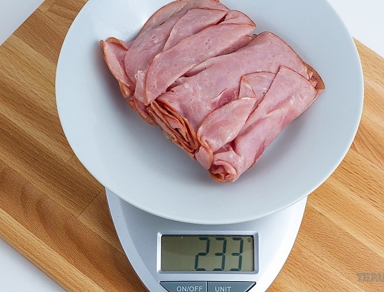 233 grams of sliced deli ham on a scale