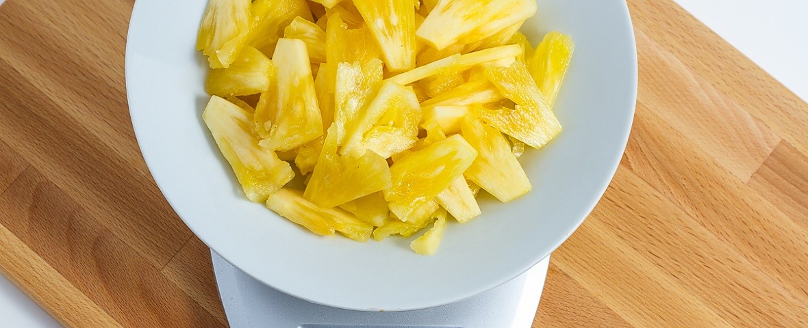 sliced pineapple on a food scale