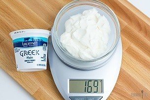 169 grams of non-fat Greek yogurt on a scale